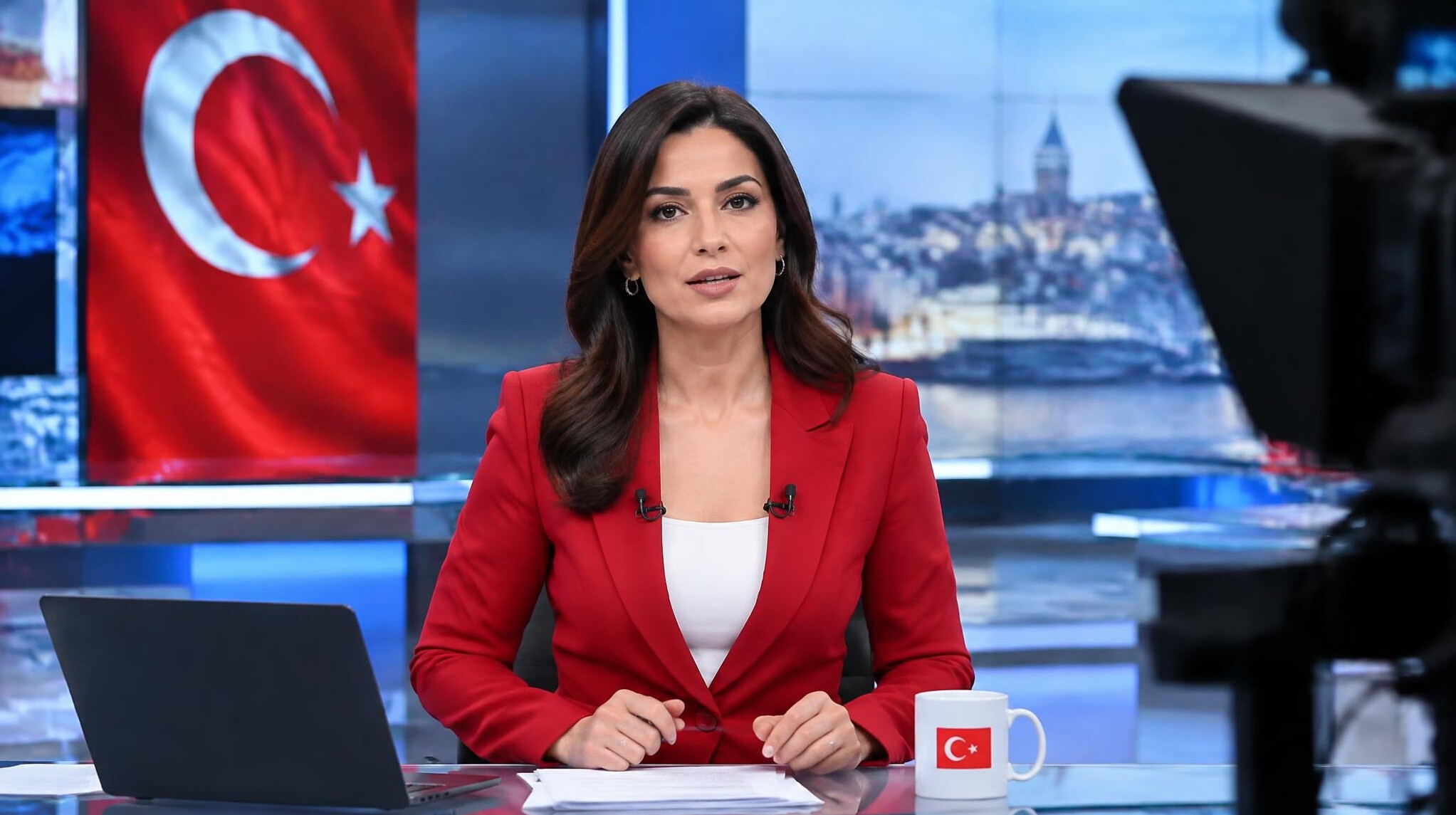 News presenter speaking on a live broadcast set